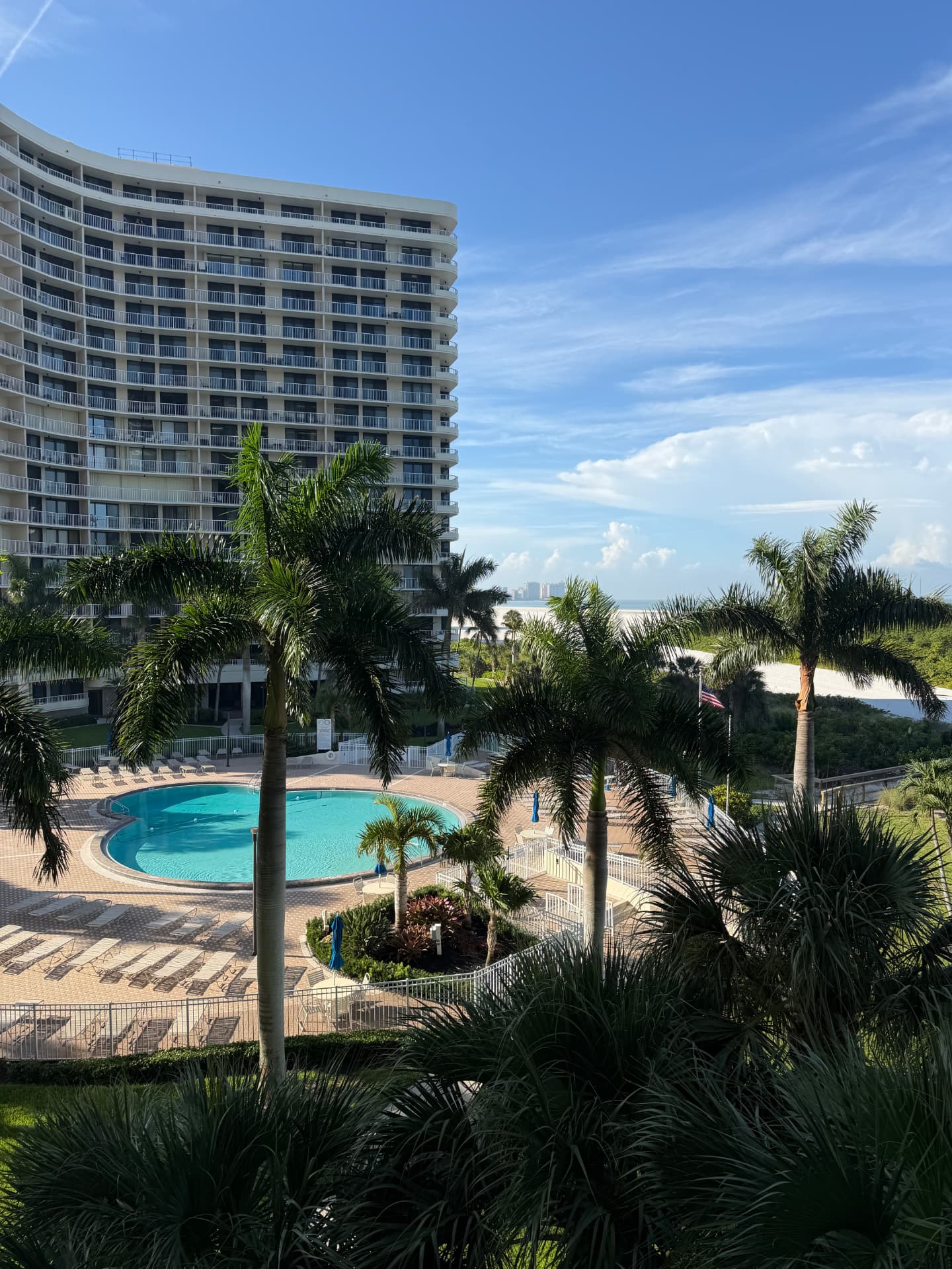 View from the balcony over the South Seas pool, palm trees and the Marco Island beach beyond